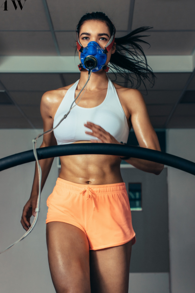 Athlete running on a treadmill wearing a gas-exchange mask during performance testing